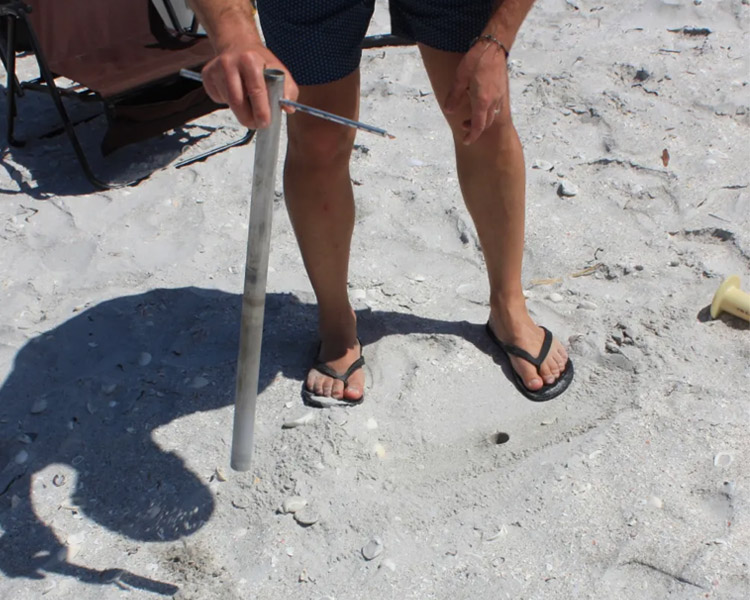 Beach Umbrella Anchoring System How To Install - shake out the sand